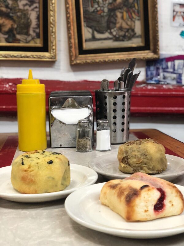 Cherry Cheese Knish for Dessert at Yonah Schimmel's with two other knishes on a table on New York's Lower East Side