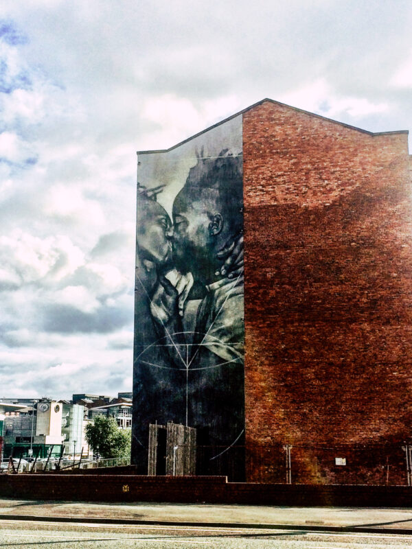 Featuring two men sharing a kiss, the mural '722 – 481 BC' by Faith47 and Lyall Sprong situated in Manchester's gay-friendly area