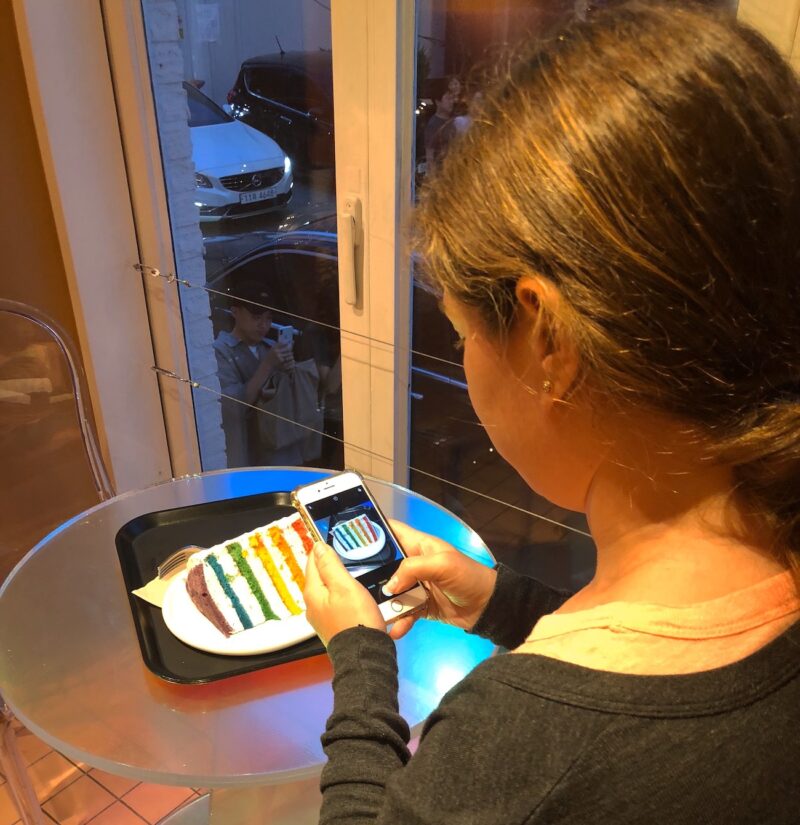 Taking a Picture of Rainbow Cake from Dore Dore in Seoul - Most Instagrammable Dessert in South Korea