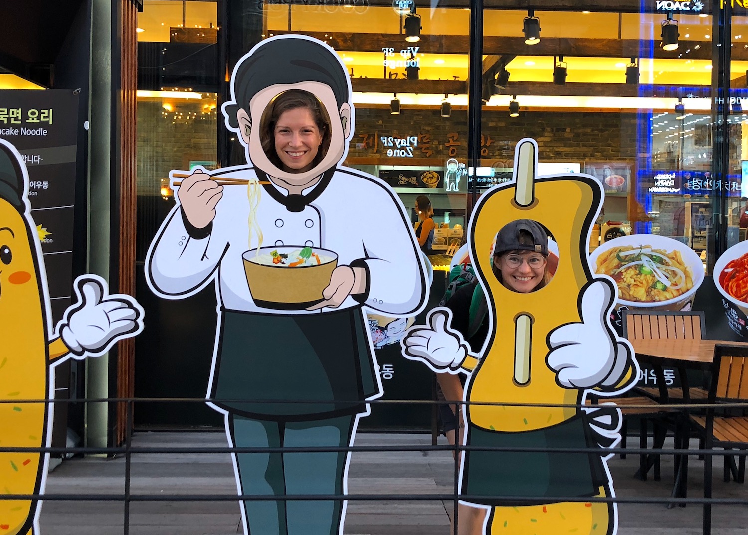 Courtney and her wife posing at a photo op in South Korea