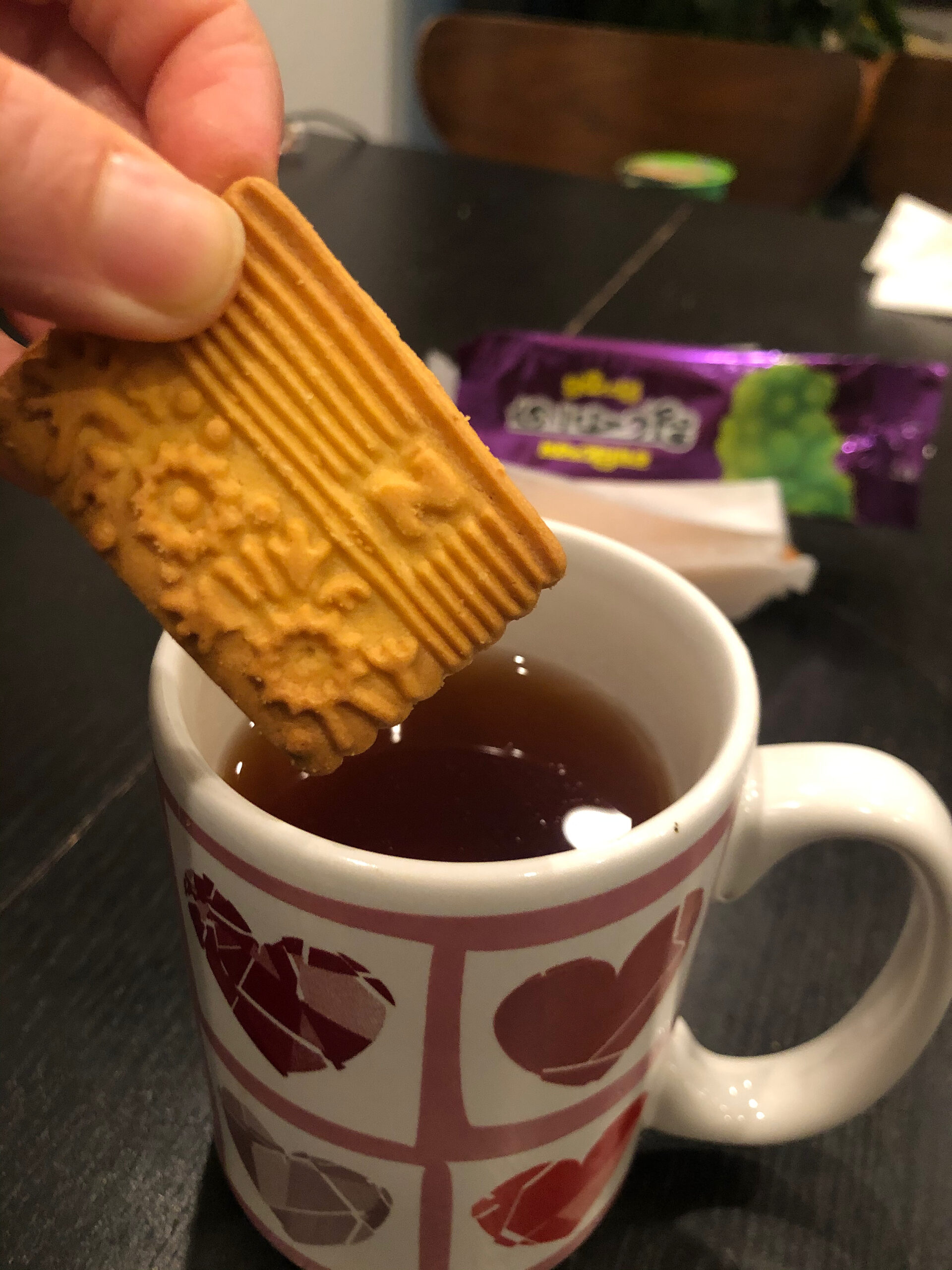 Nabisco Glucose Biscuit being dipping into a cup of tea.