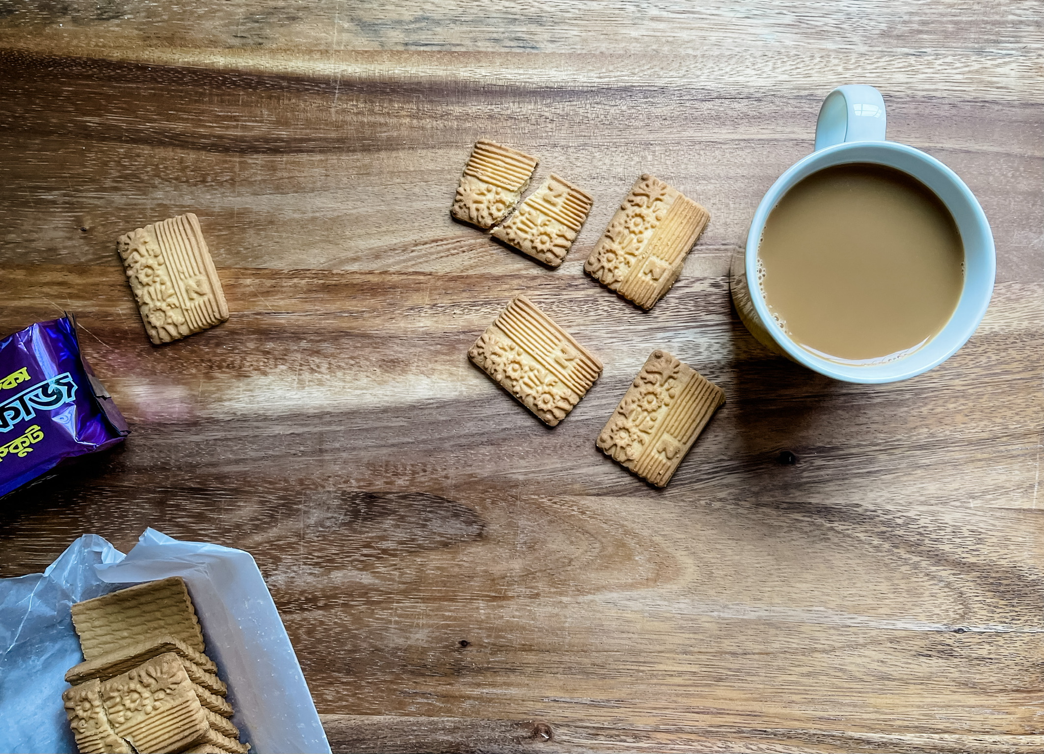 Nabisco Glucose Biscuits on a wooden table with a cup of tea
