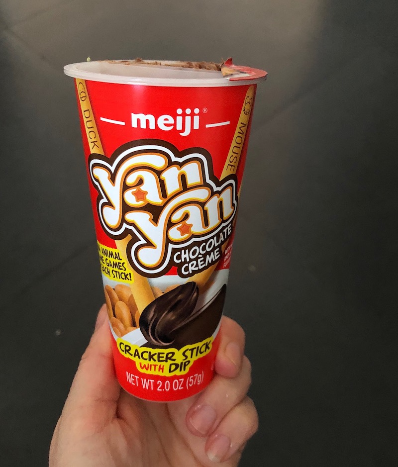 Yan Yan Chocolate Creme Snack Being Held in Hand