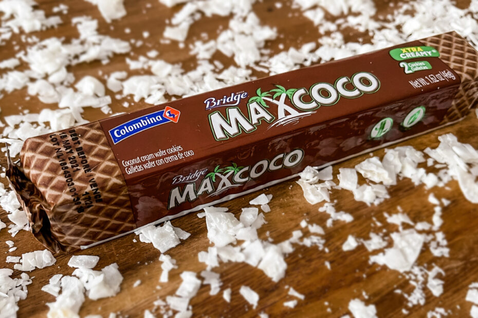 Max Coco Colombian wafer cookie bar on a table surrounded by coconut chips
