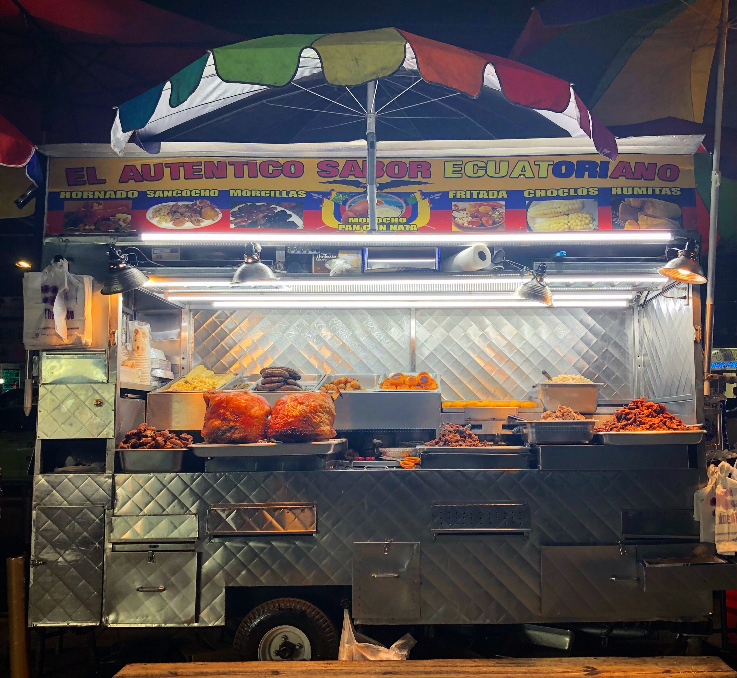 Ecuadorian Food Cart Parked on Roosevelt Avenue in Queens at night with fresh meat