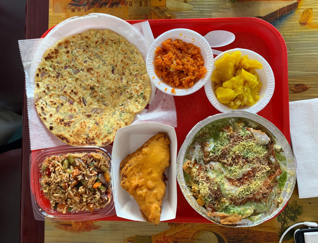 Meal from Raja Sweets & Fast Food - Plate with Samosa Chat, a dosa and other dishes