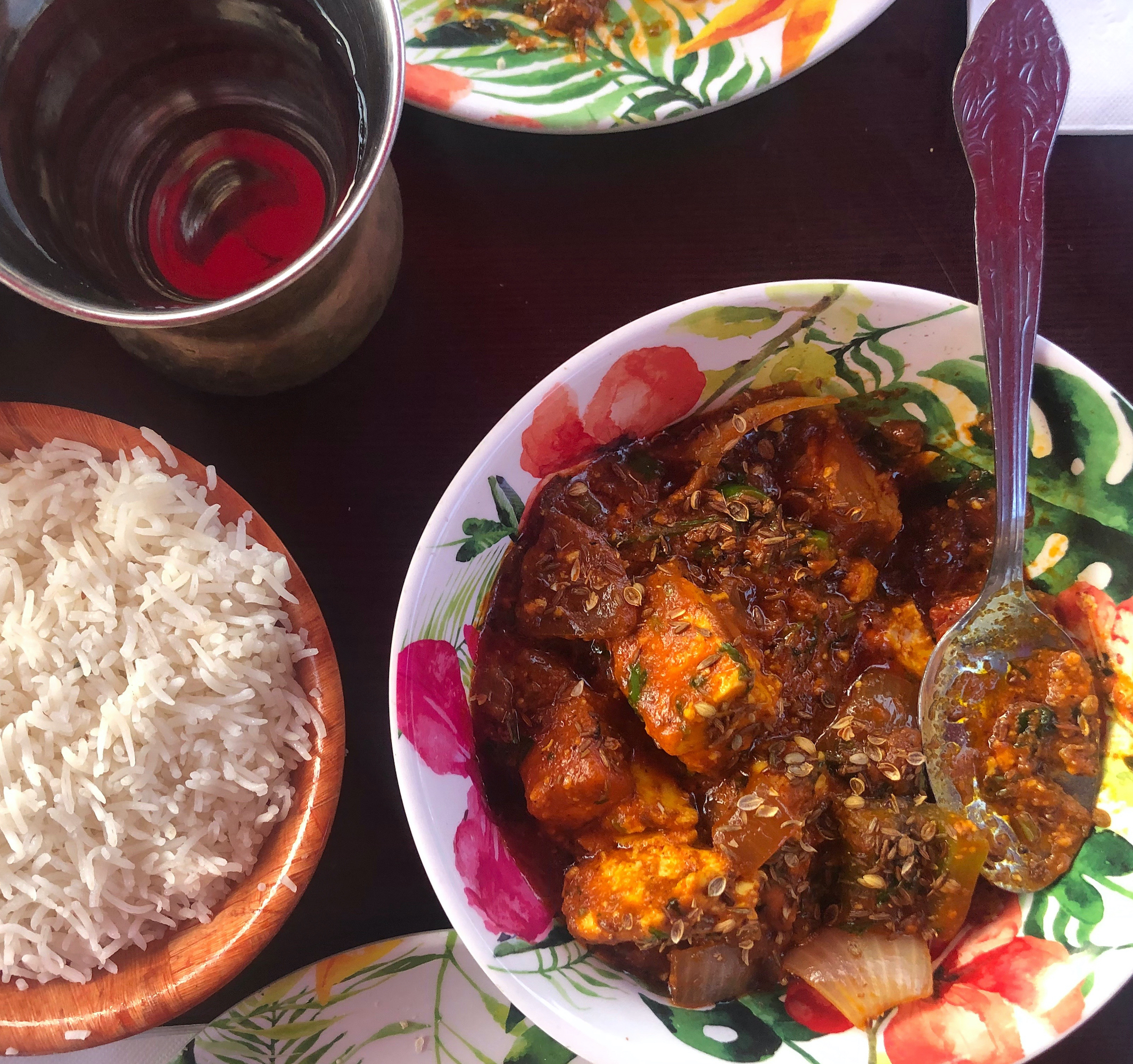 Paneer Khurchan, rice and a cup of water on a table at Angel Indian Restaurant