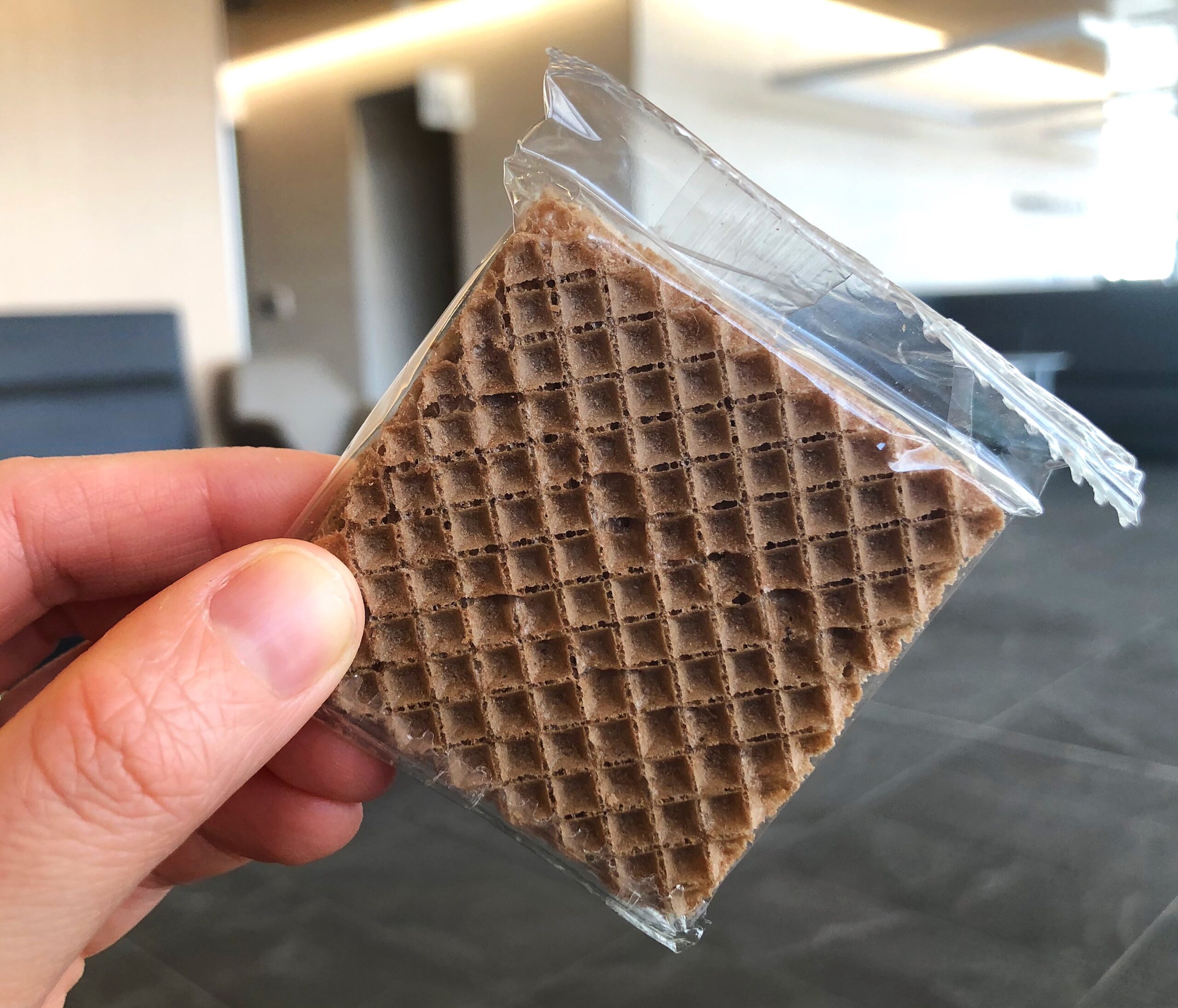 Single Square of Hanuta Chocolate Hazelnut Wafer Bar in plastic packaging being held