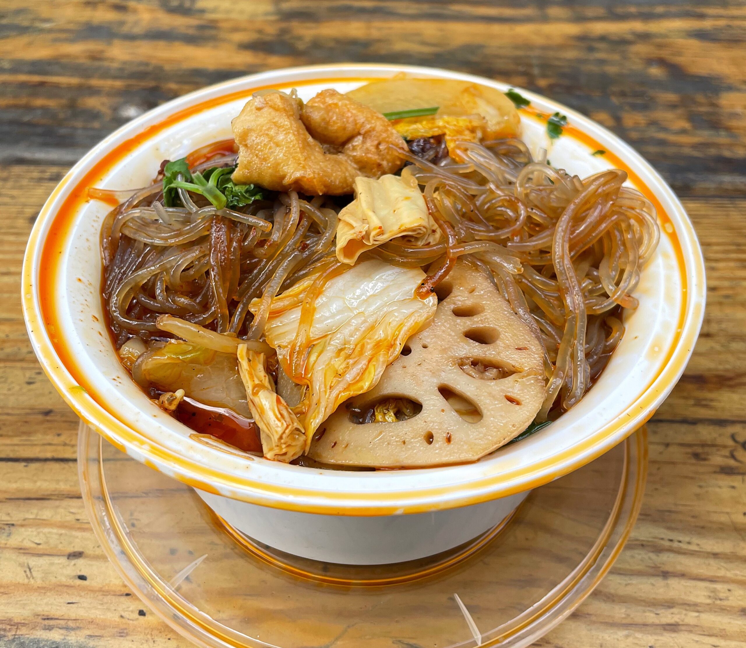 A bowl of Spicy Vegetable Soup from Lao Bei Fang on a wooden table
