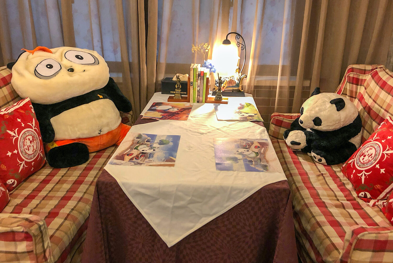 Panda Cafe in Chengdu with a table and two stuffed animal pandas sitting on the benches