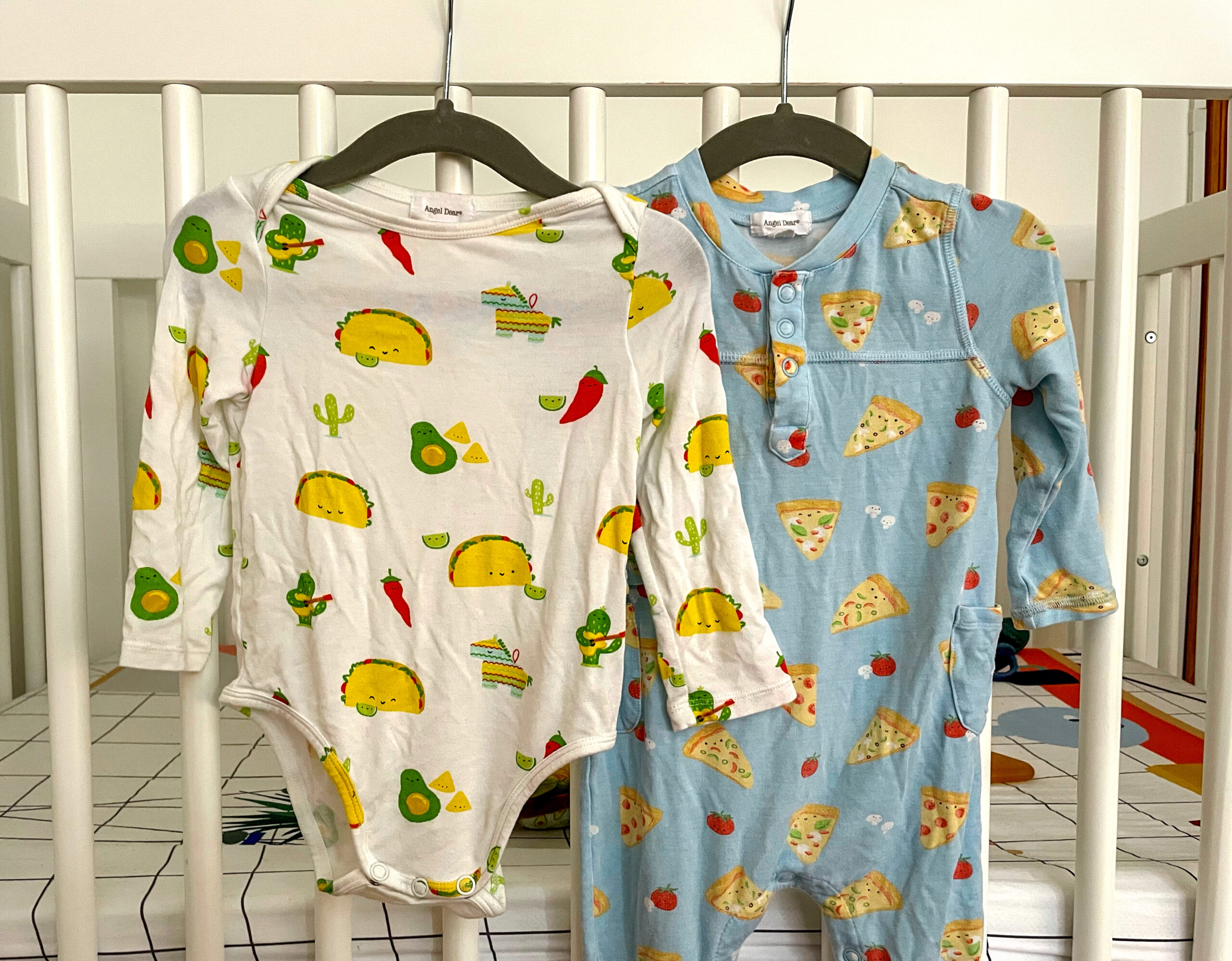 Dear Angel Food-themed Onesies for Babies hanging on a white crib