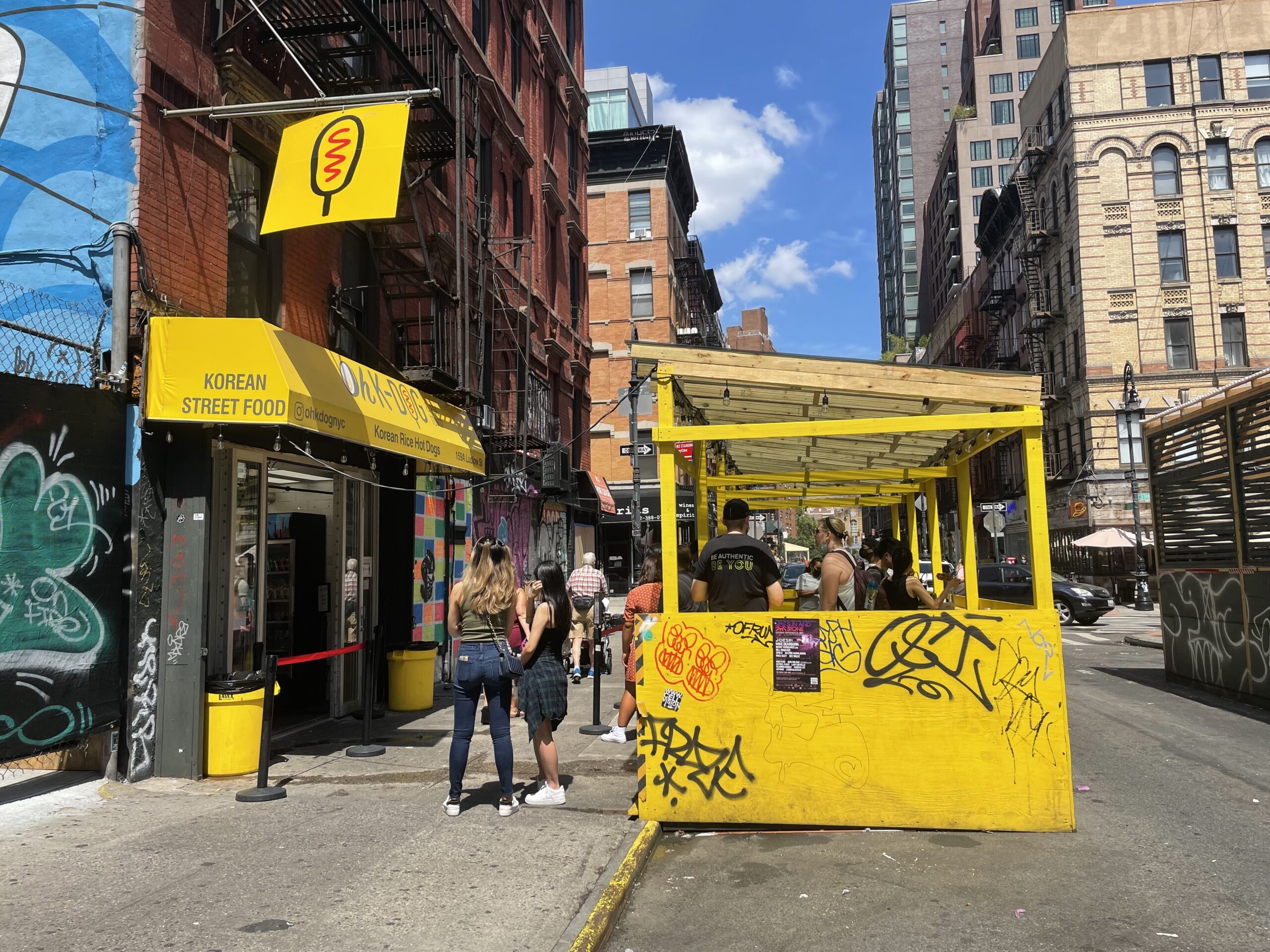 Busy storefront on a summer day at Oh-K Dog in Manhattan